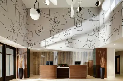 a lobby with a wall with drawings on the ceiling at Courtyard by Marriott Los Angeles Pasadena Old Town in Pasadena