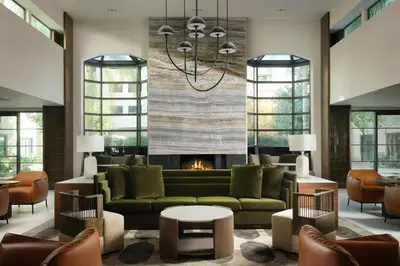 a living room with a couch and a fireplace at Courtyard by Marriott Los Angeles Pasadena Old Town in Pasadena
