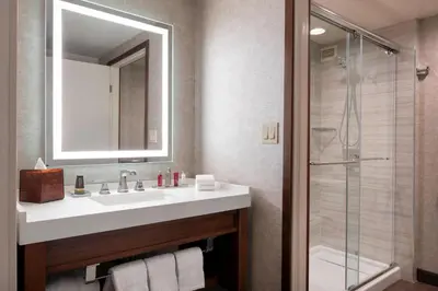 a bathroom with a sink and a shower at Fullerton Marriott at California State University in Fullerton