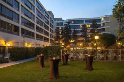 a row of stools in the grass in front of a building at Fullerton Marriott at California State University in Fullerton