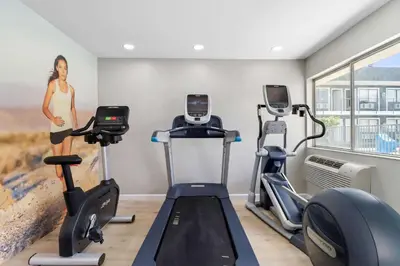 a fitness room with treadmills and cardio machines at Clarion Pointe Ridgecrest near China Lake Naval Station in Ridgecrest