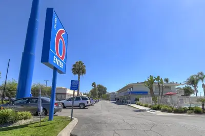 a sign for a gas station in a parking lot at Motel 6-San Bernardino, CA - South in San Bernardino