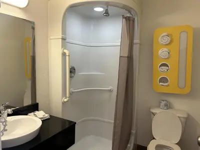 a bathroom with a shower and a toilet and a sink at Motel 6-Stanton, CA- Anaheim West in Stanton