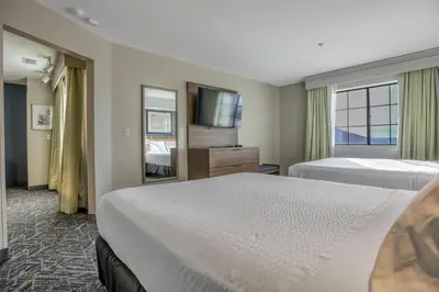 a hotel room with two beds and a television at Best Western Hesperia-Victorville Suites in Hesperia