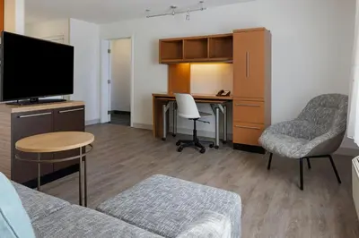 a living room with a couch and a desk at TownePlace Suites by Marriott Ontario Airport in Rancho Cucamonga