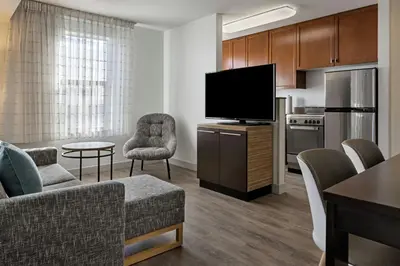 a living room with a couch and a flat screen tv at TownePlace Suites by Marriott Ontario Airport in Rancho Cucamonga