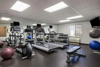 a gym with several exercise equipment in a room at TownePlace Suites by Marriott Ontario Airport in Rancho Cucamonga