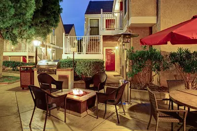 a patio with tables and chairs and a grill at Residence Inn by Marriott Ontario Airport in Ontario