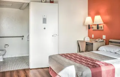 a hotel room with a bed and a toilet at Motel 6-Mojave, CA in Mojave