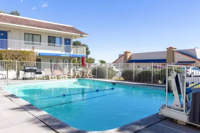 a swimming pool in front of a building at Motel 6-Mojave, CA in Mojave