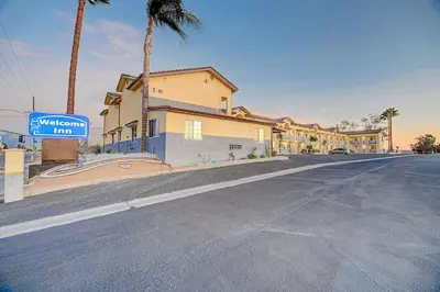 a street with a sign in front of a building at Welcome Inn San Bernardino/ Colton in Colton