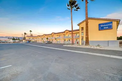 an empty parking lot in front of a hotel at Welcome Inn San Bernardino/ Colton in Colton