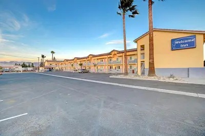 an empty parking lot in front of a hotel at Welcome Inn San Bernardino/ Colton in Colton