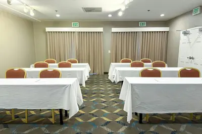 a conference room with white tables and chairs at Residence Inn La Mirada Buena Park in La Mirada