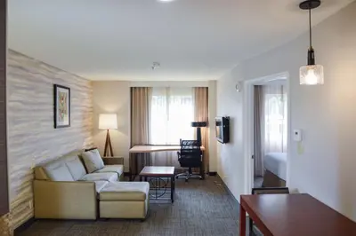 a living room with a couch and a room with a bed at Residence Inn La Mirada Buena Park in La Mirada