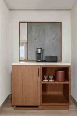 a mirror on top of a wooden cabinet in a room at Anaheim Marriott Suites in Anaheim