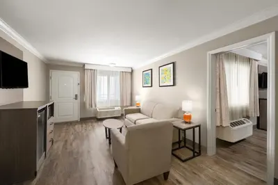 a living room with a couch and a table at Solara Inn and Suites in Anaheim