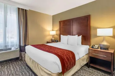 a hotel room with a large bed and a telephone at Comfort Inn Monterey Park - Los Angeles in Monterey Park