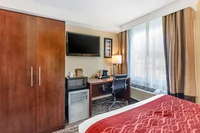 a hotel room with a bed and a desk and a television at Comfort Inn Monterey Park - Los Angeles in Monterey Park