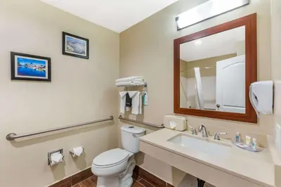 a bathroom with a toilet and a sink and a mirror at Comfort Inn Monterey Park - Los Angeles in Monterey Park