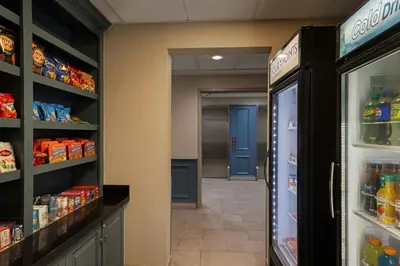a grocery store aisle with a refrigerator and a hallway at Four Points by Sheraton, Ontario-Rancho Cucamonga in Rancho Cucamonga