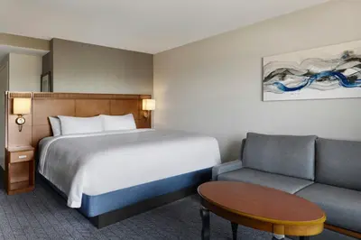 a hotel room with a bed and a couch at Courtyard Ventura Simi Valley in Simi Valley