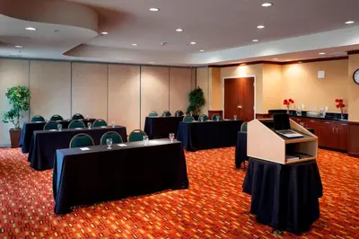 a conference room with tables and chairs and a podium at Courtyard Ventura Simi Valley in Simi Valley