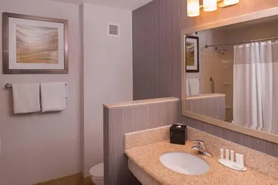 a bathroom with a sink and a mirror at Courtyard by Marriott Thousand Oaks Ventura County in Thousand Oaks