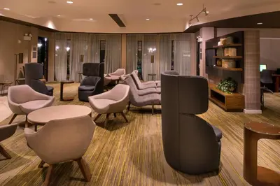 a waiting room with chairs and tables and a salon at Courtyard by Marriott Thousand Oaks Ventura County in Thousand Oaks