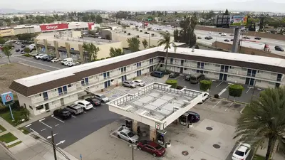 an overhead view of a parking lot in front of a building at Motel 6 Ontario, CA - Airport in Ontario