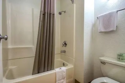 a bathroom with a shower curtain and a toilet at Motel 6-Rowland Heights, CA - Los Angeles - Pomona in Rowland Heights