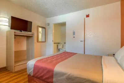 a hotel room with a bed and a bathroom at Motel 6-Rowland Heights, CA - Los Angeles - Pomona in Rowland Heights