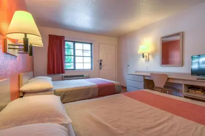 a hotel room with two beds and a desk at Motel 6-San Dimas, CA - Los Angeles in San Dimas
