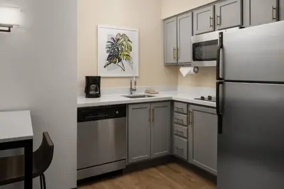 a kitchen with a stainless steel refrigerator and cabinets at Residence Inn by Marriott Anaheim Resort Area/Garden Grove in Anaheim