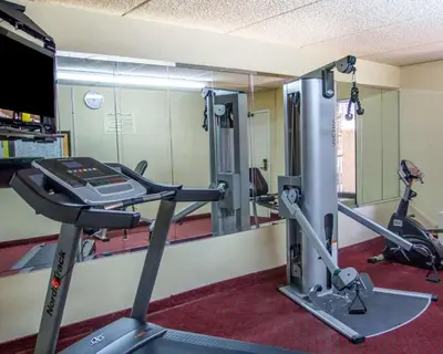 a gym with two tread machines and a mirror at Quality Inn Riverside near UCR and Downtown in Riverside