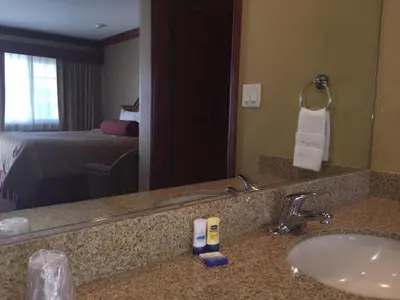 a hotel bathroom with a sink and a mirror at Thunderbird Lodge in Riverside