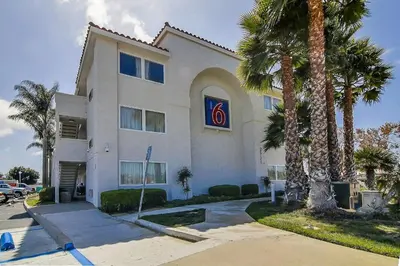 a white building with palm trees in front of it at Motel 6-Ventura, CA - South in Ventura
