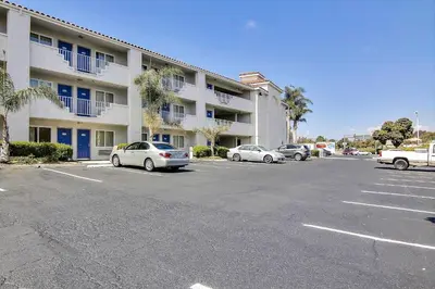 a parking lot in front of a large apartment building at Motel 6-Ventura, CA - South in Ventura