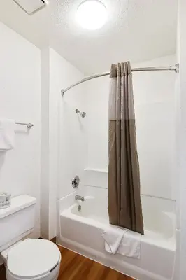 a bathroom with a toilet and a bath tub at Motel 6-Ventura, CA - South in Ventura