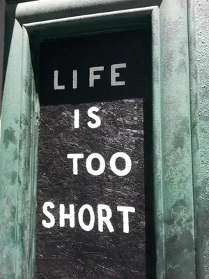 a sign that says life is too short at Hollywood VIP Hotel in Los Angeles