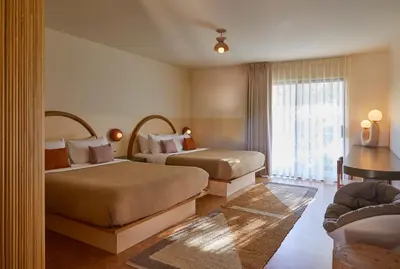 a hotel room with two beds and a window at The Capri Hotel in Ojai