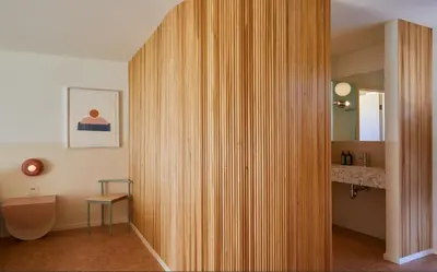 a hallway with a wooden wall in a bathroom at The Capri Hotel in Ojai