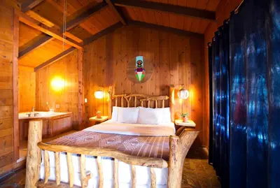 a bedroom with a bed in a wooden room at Ojai Rancho Inn in Ojai