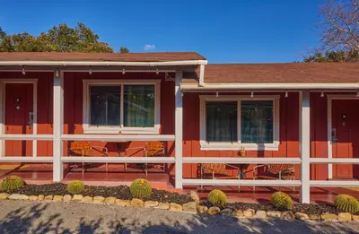 a red house with tables and chairs in front of it at Ojai Rancho Inn in Ojai