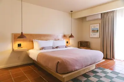 a bedroom with a large bed in a room at Hummingbird Inn in Ojai