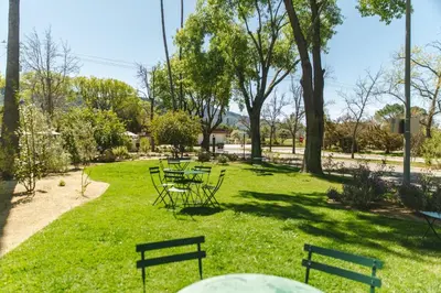 a park with benches and tables in the grass at Hummingbird Inn in Ojai