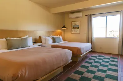 a hotel room with two beds and a window at Hummingbird Inn in Ojai