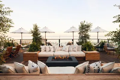a patio with a couch and a fire pit at The Surfrider Malibu in Malibu