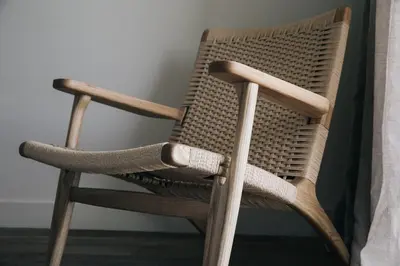 a brown wicker chair sitting in a room at The Surfrider Malibu in Malibu