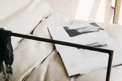 a book sitting on top of a bed at The Surfrider Malibu in Malibu